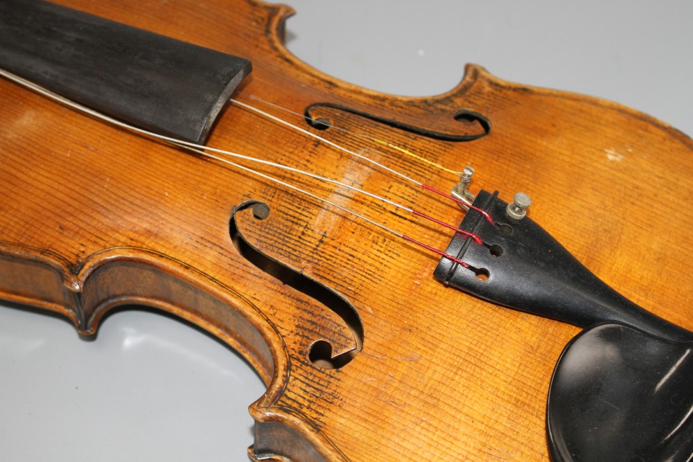 A violin with two piece back and bow, and a childs violin with bow, both with cases